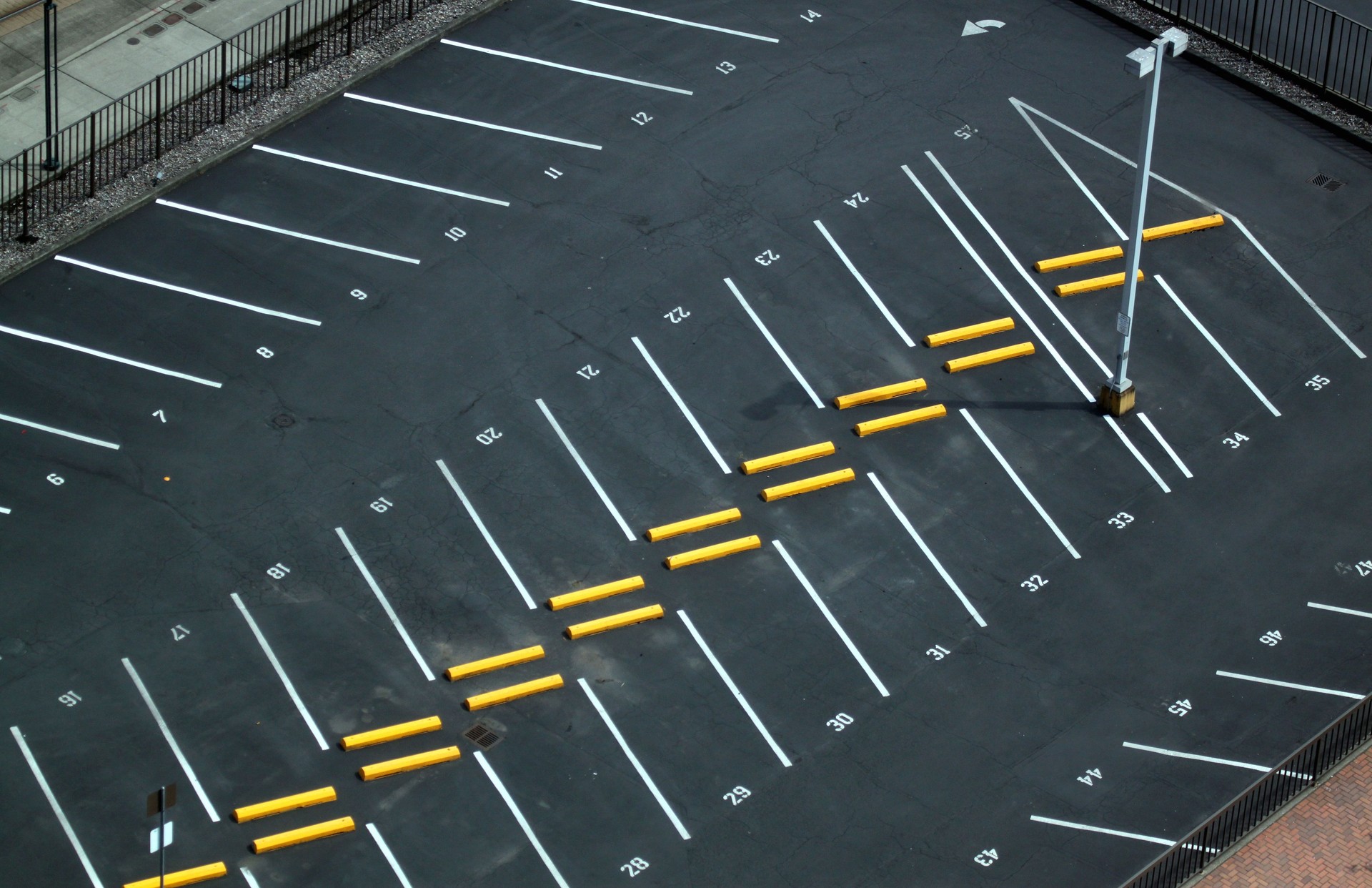 Abstract shots of parking lot with white and yellow stripes, arrows, crosswalks, signs, and symbols